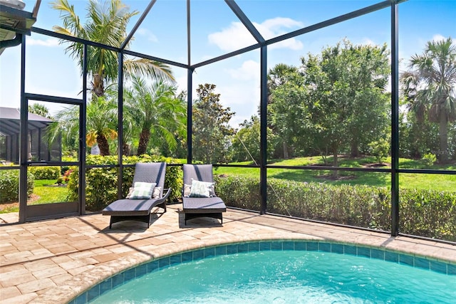 outdoor pool with a patio and glass enclosure