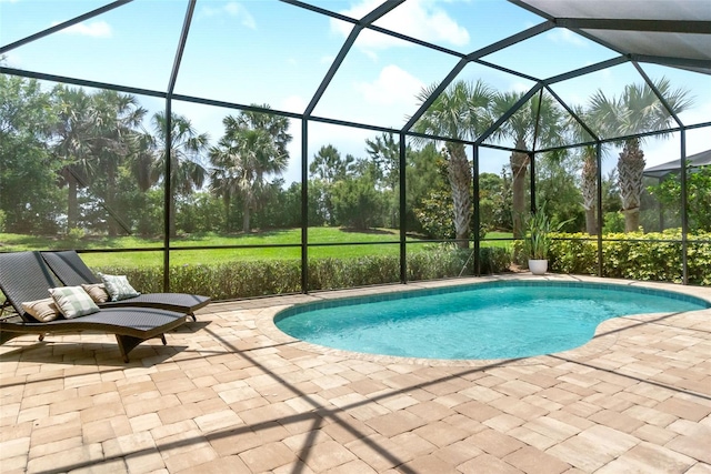 outdoor pool with a patio and glass enclosure