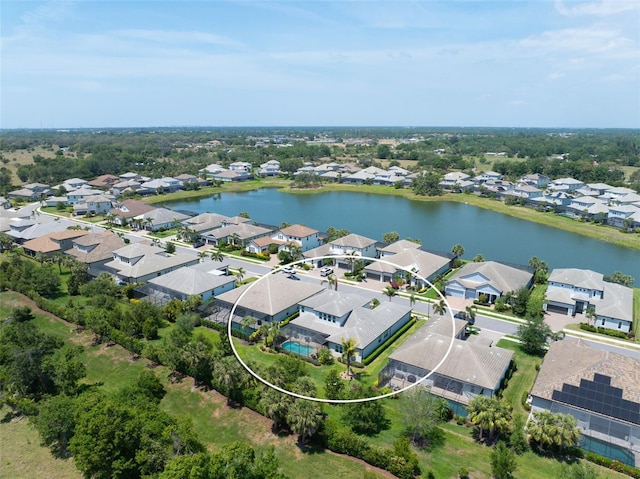 drone / aerial view with a residential view and a water view