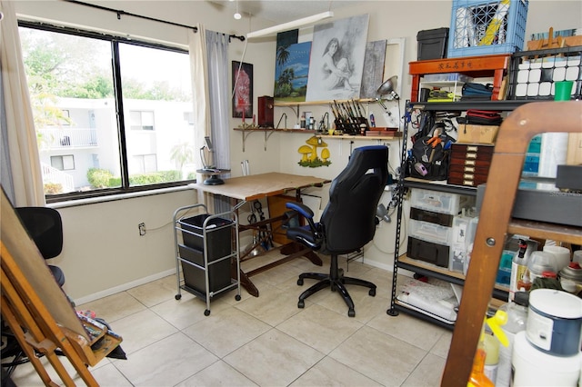 tiled office space featuring a wealth of natural light and baseboards