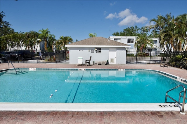 pool featuring fence and a patio area