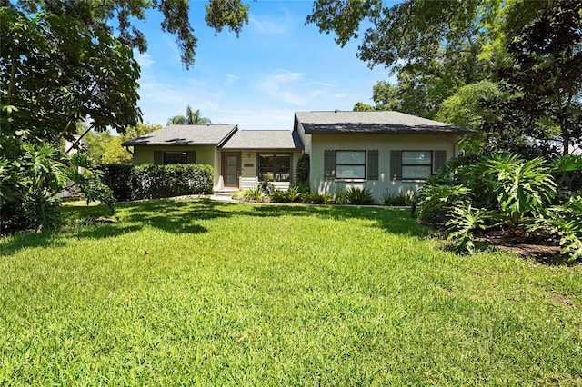 view of front of property with stucco siding and a front lawn