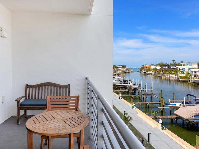 balcony featuring a water view and a dock