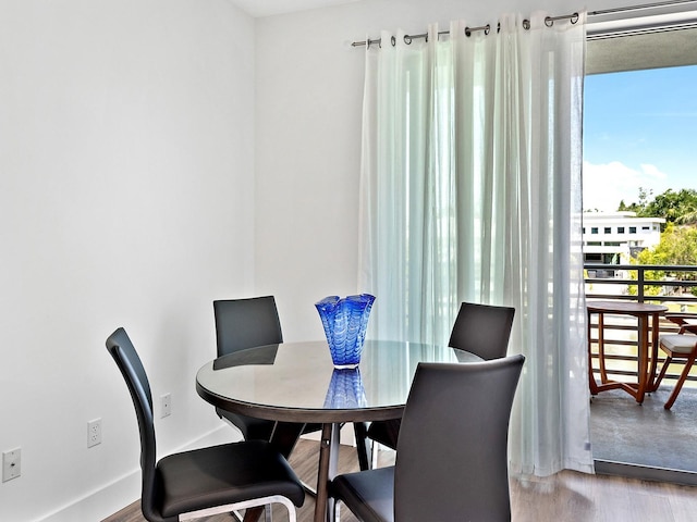 dining space with wood finished floors