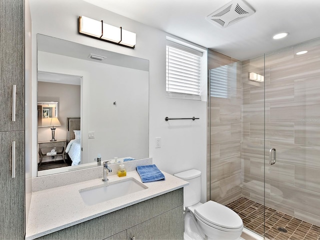 bathroom featuring a stall shower, toilet, visible vents, vanity, and connected bathroom