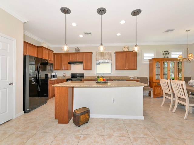 5952 Snowy Egret Dr, Sarasota, FL 34238 - kitchen featuring a center island, under cabinet range hood, visible vents, brown cabinetry, and black appliances