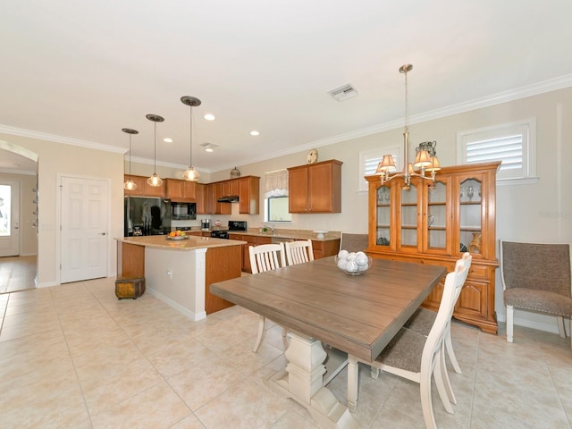 5952 Snowy Egret Dr, Sarasota, FL 34238 - dining room featuring crown molding, visible vents, and light tile patterned floors