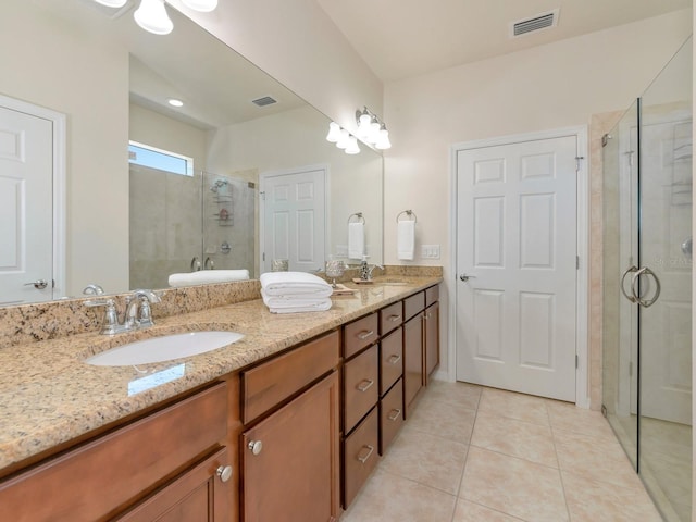5952 Snowy Egret Dr, Sarasota, FL 34238 - bathroom with tile patterned floors, visible vents, a sink, and a stall shower