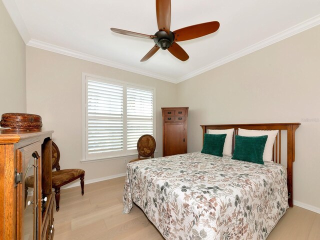 5952 Snowy Egret Dr, Sarasota, FL 34238 - bedroom featuring light wood-style flooring, baseboards, and ornamental molding