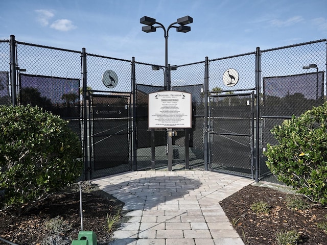 5952 Snowy Egret Dr, Sarasota, FL 34238 - view of tennis court with a gate