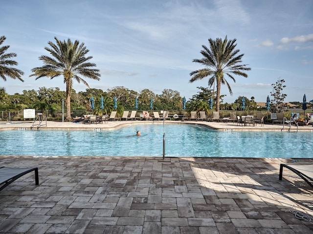 5952 Snowy Egret Dr, Sarasota, FL 34238 - community pool featuring a patio area and fence