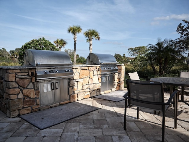 5952 Snowy Egret Dr, Sarasota, FL 34238 - view of patio / terrace featuring area for grilling, an outdoor kitchen, and outdoor dining area