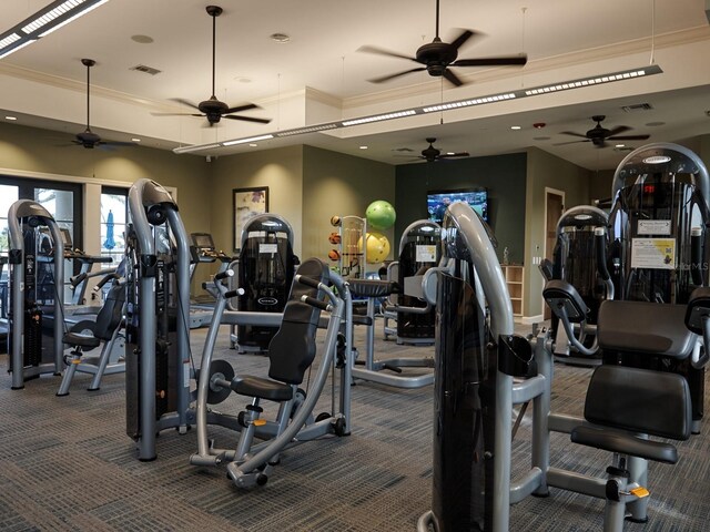 5952 Snowy Egret Dr, Sarasota, FL 34238 - gym with ornamental molding, visible vents, a ceiling fan, and carpet