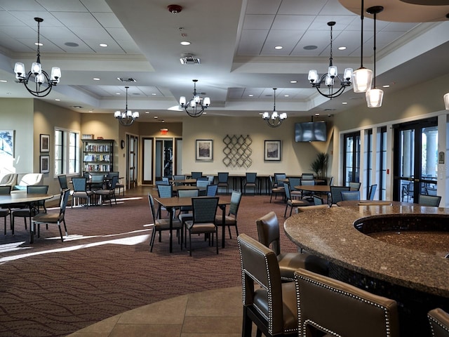 5952 Snowy Egret Dr, Sarasota, FL 34238 - carpeted dining room featuring a tray ceiling, recessed lighting, an inviting chandelier, and tile patterned flooring