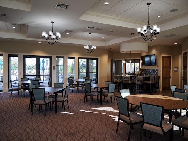 5952 Snowy Egret Dr, Sarasota, FL 34238 - dining room featuring visible vents, a raised ceiling, and an inviting chandelier