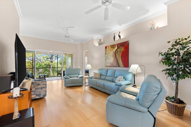 living area with a ceiling fan, crown molding, and wood finished floors