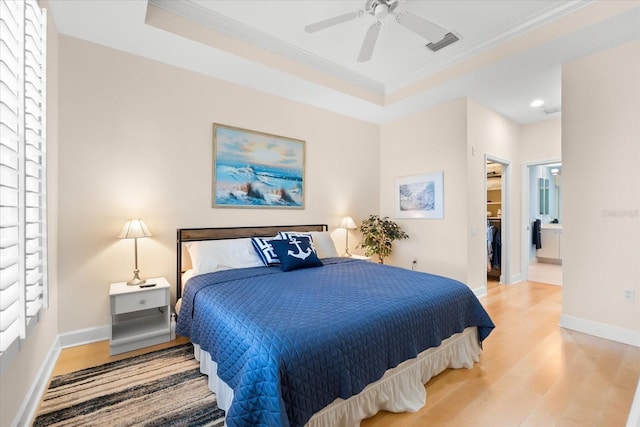 bedroom featuring ornamental molding, visible vents, a spacious closet, and wood finished floors