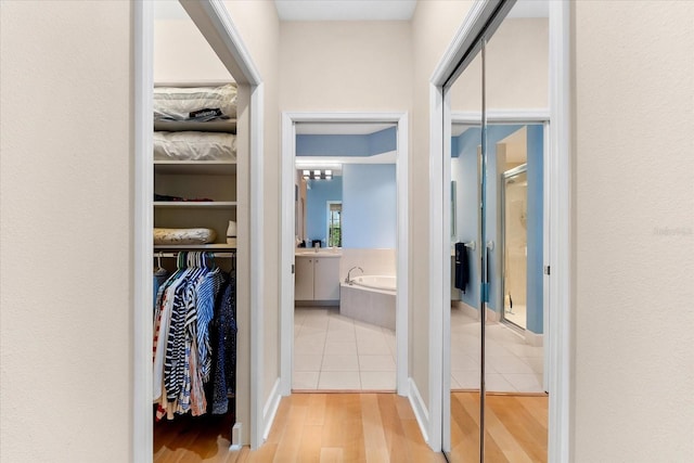 hallway featuring a sink and tile patterned flooring
