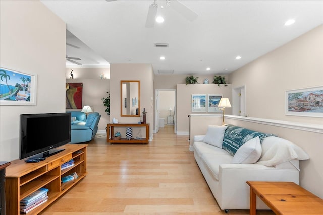 living area with recessed lighting, a ceiling fan, light wood-style floors, and baseboards