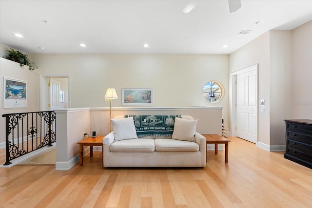 sitting room with baseboards, recessed lighting, an upstairs landing, ceiling fan, and wood finished floors