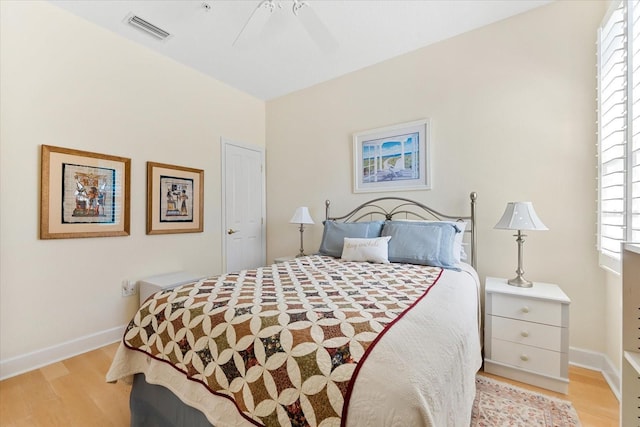 bedroom featuring light wood-style flooring, ceiling fan, baseboards, and visible vents
