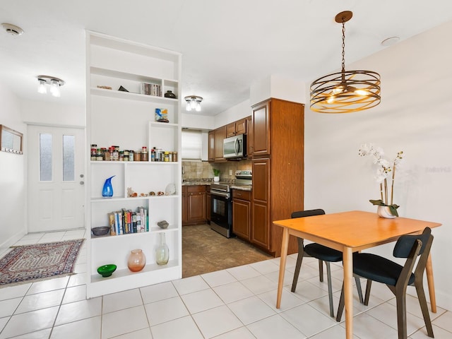 kitchen featuring open shelves, an inviting chandelier, brown cabinets, stainless steel appliances, and backsplash