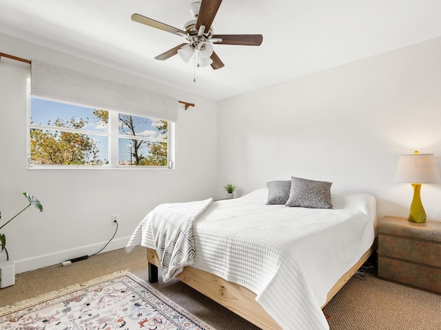 bedroom featuring baseboards and ceiling fan