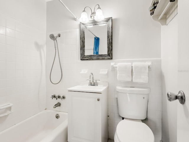 bathroom with bathing tub / shower combination, vanity, tile walls, and toilet