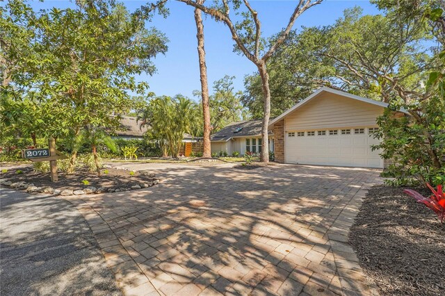 view of front of home with an attached garage and decorative driveway