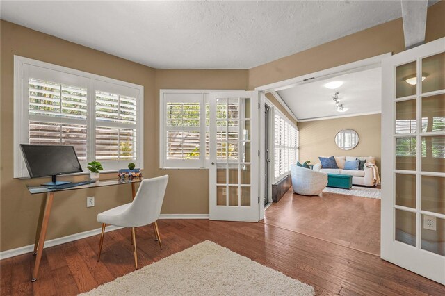office featuring baseboards, french doors, and hardwood / wood-style flooring