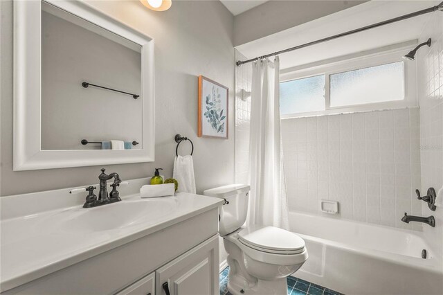 full bathroom with vanity, shower / tub combo with curtain, tile patterned floors, and toilet