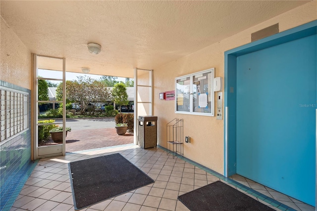4570 Pinebrook Cir Unit 406, Bradenton, FL 34209 - doorway to outside featuring a textured ceiling, a textured wall, light tile patterned floors, and floor to ceiling windows
