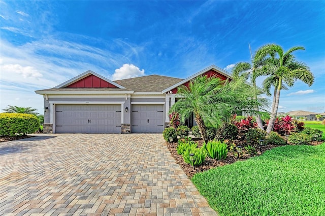 view of front of house featuring stone siding, board and batten siding, decorative driveway, and an attached garage