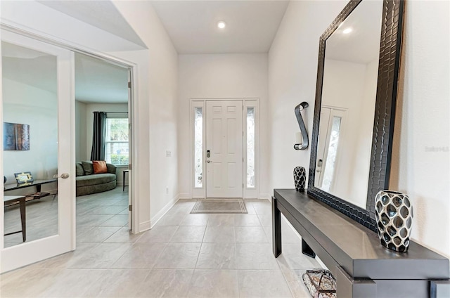 entrance foyer featuring light tile patterned floors and baseboards