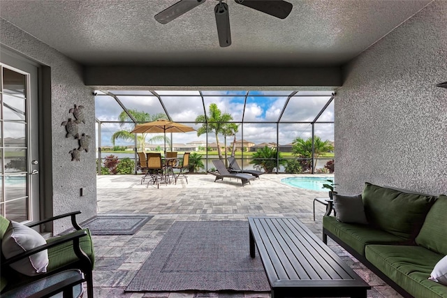 view of patio with an outdoor hangout area, an outdoor pool, a ceiling fan, a lanai, and outdoor dining area