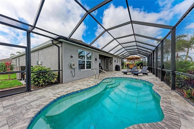 outdoor pool with a patio area and glass enclosure