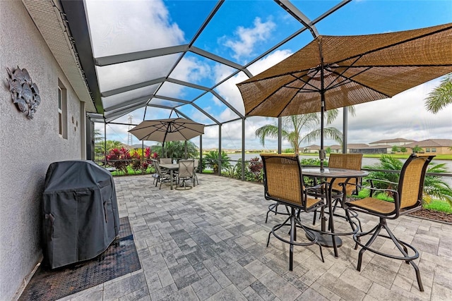 view of patio with grilling area, a lanai, and outdoor dining area