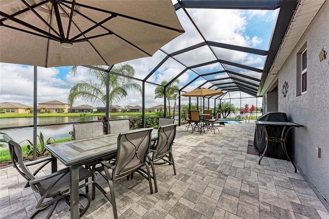 view of patio / terrace featuring a water view, outdoor dining space, a grill, and a lanai