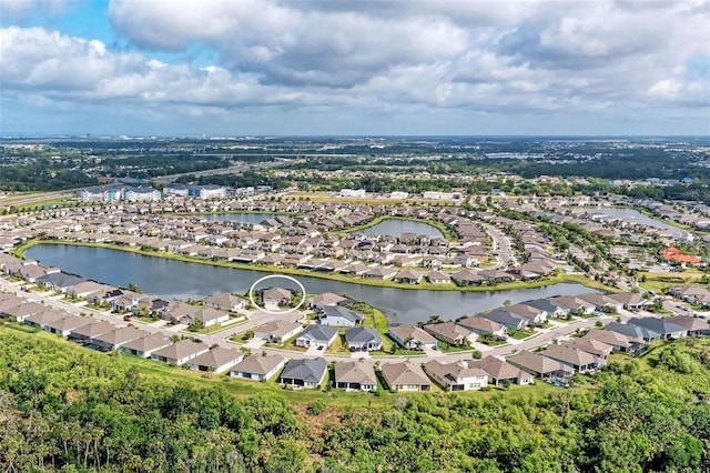 drone / aerial view featuring a water view and a residential view