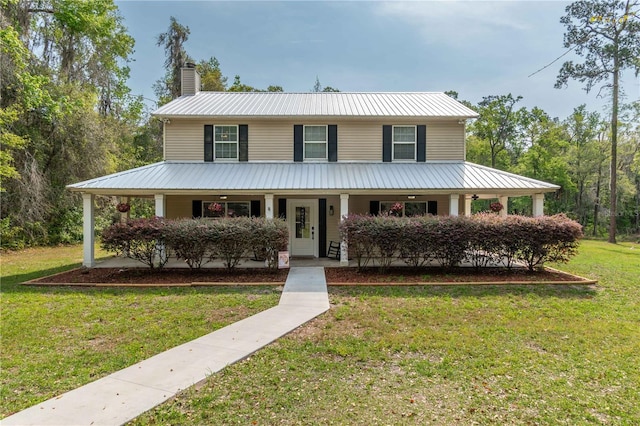 3333 SE 3rd Ave, Ocala, FL 34471 - farmhouse inspired home featuring metal roof, a chimney, a front lawn, and a porch