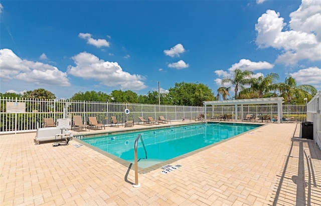 pool featuring fence and a patio area