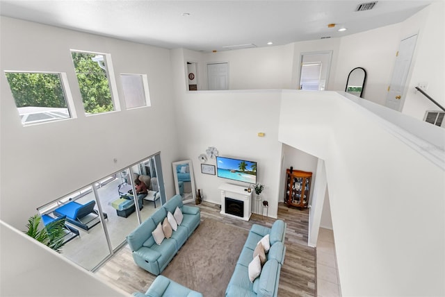 living area with visible vents, recessed lighting, and wood finished floors