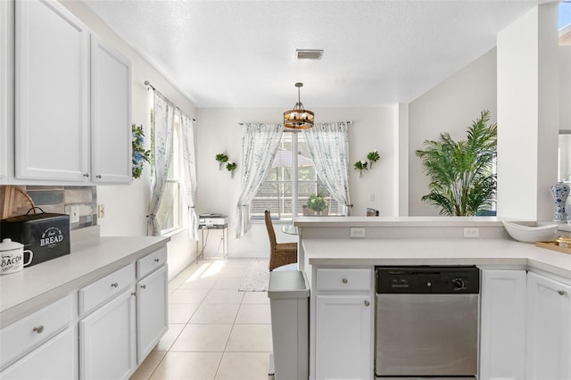 kitchen with dishwasher, light countertops, a peninsula, white cabinetry, and visible vents