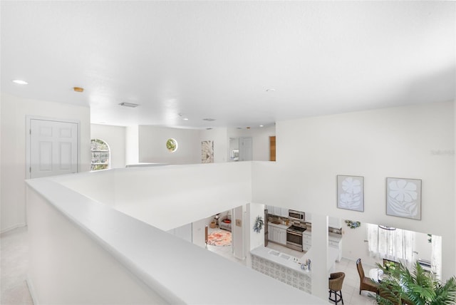 interior space featuring stainless steel microwave, recessed lighting, and oven
