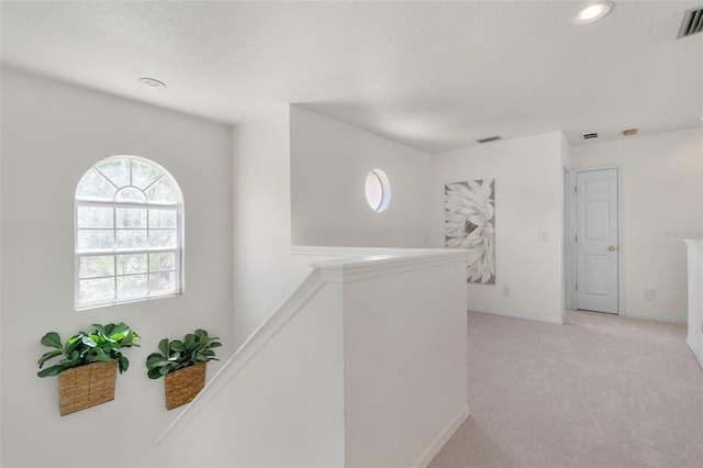 corridor with visible vents, light carpet, baseboards, recessed lighting, and an upstairs landing