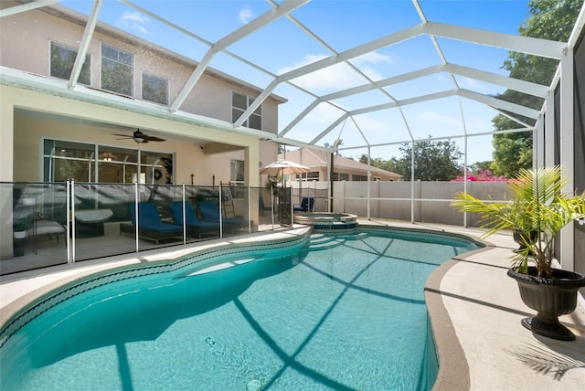 view of swimming pool with a patio, a ceiling fan, a lanai, and a pool with connected hot tub