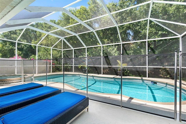 view of swimming pool featuring a fenced in pool, glass enclosure, a hot tub, and a patio
