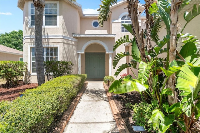 property entrance featuring stucco siding