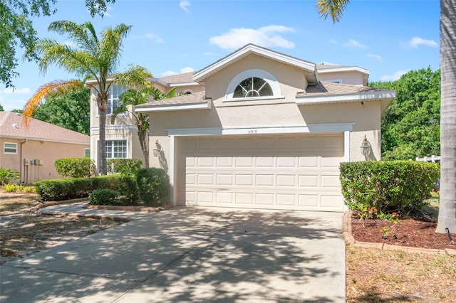view of front of property featuring stucco siding and concrete driveway