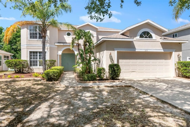 view of front of house featuring a garage, stucco siding, and concrete driveway